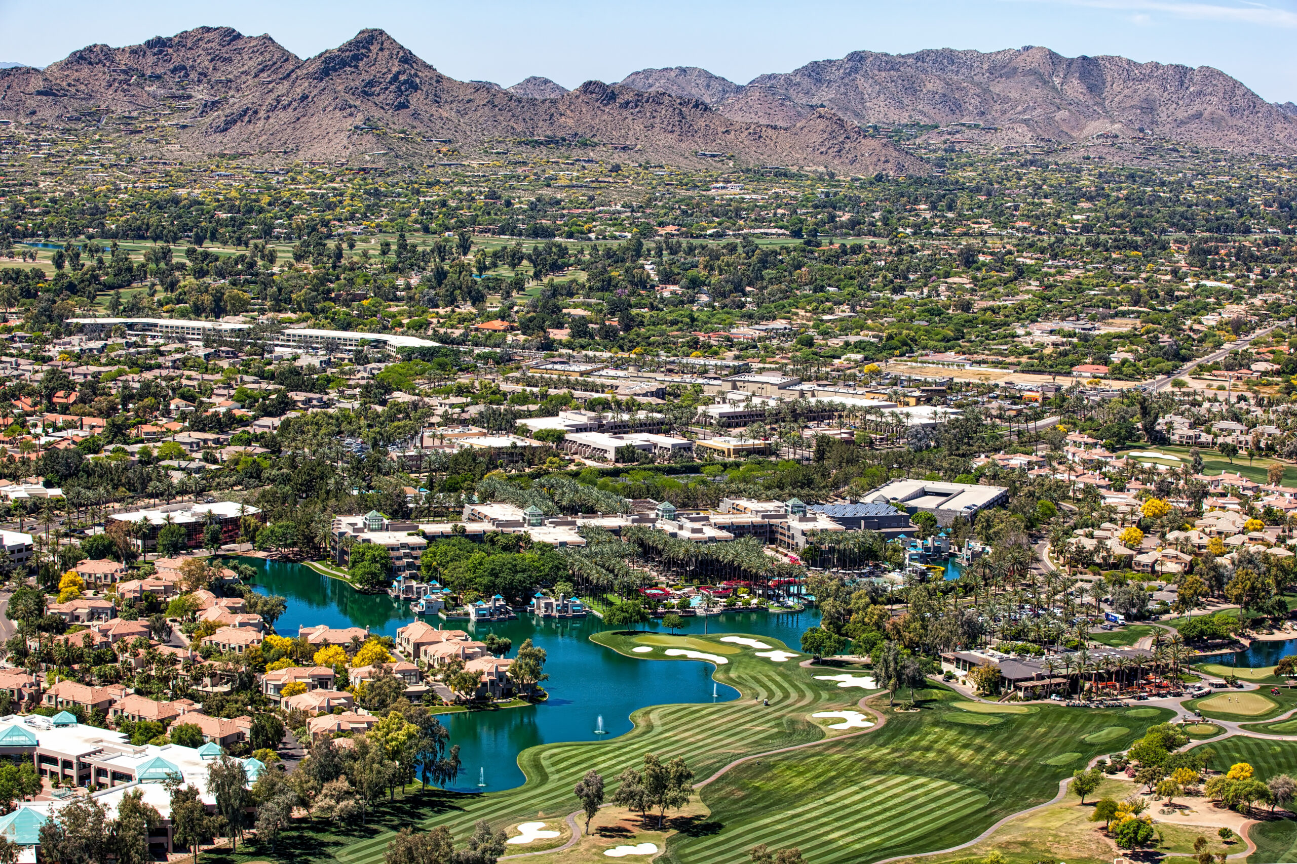 Over Scottsdale, Arizona looking to the southwest at golf courses, resorts, luxury homes and Mummy Mountain
